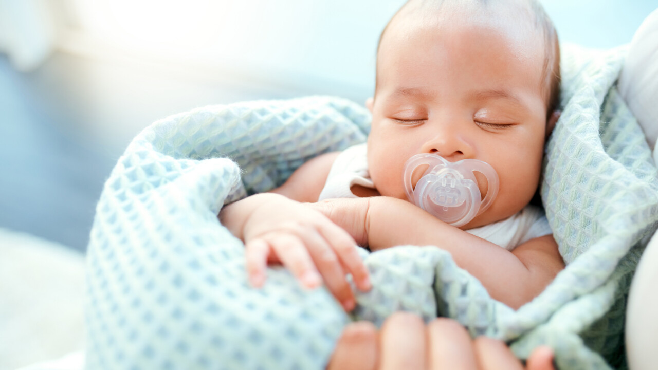 Infant in blanket.