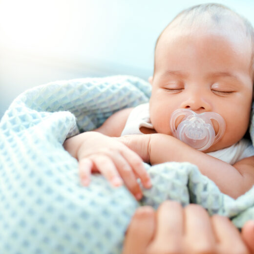 Infant in blanket.