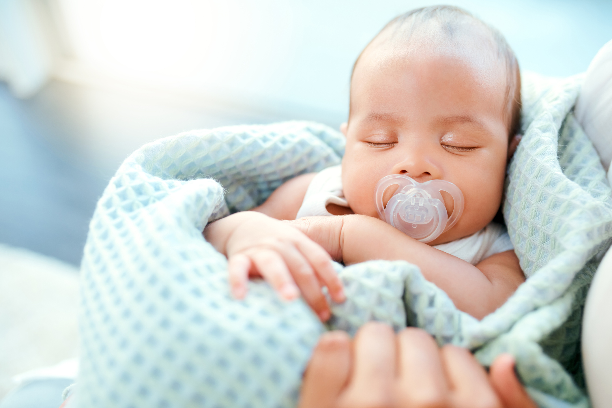 Infant in blanket.